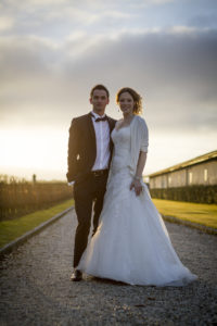 Couple de jeunes mariés posant dans les vignes du Château Pape-Clément Bernard Magrez Luxury Wine Experience sous l'oeil du photographe de mariages à Bordeaux Sébastien Huruguen